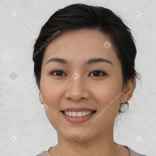 Joyful asian young-adult female with medium  black hair and brown eyes