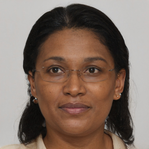 Joyful black adult female with medium  brown hair and brown eyes