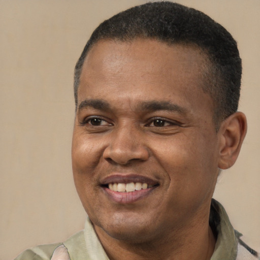 Joyful latino adult male with short  black hair and brown eyes