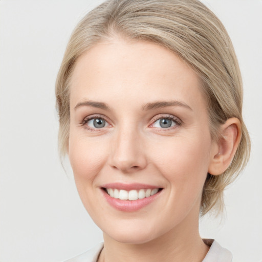 Joyful white young-adult female with medium  brown hair and blue eyes