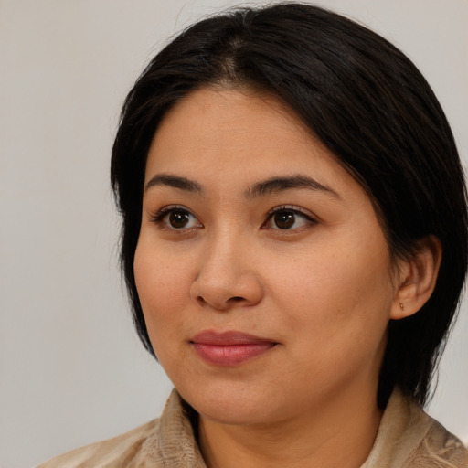 Joyful latino young-adult female with medium  black hair and brown eyes