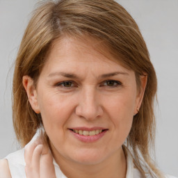 Joyful white adult female with medium  brown hair and brown eyes