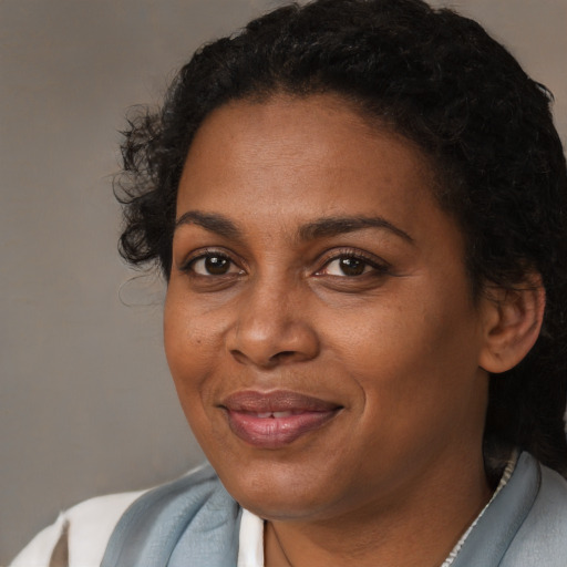 Joyful black adult female with short  black hair and brown eyes