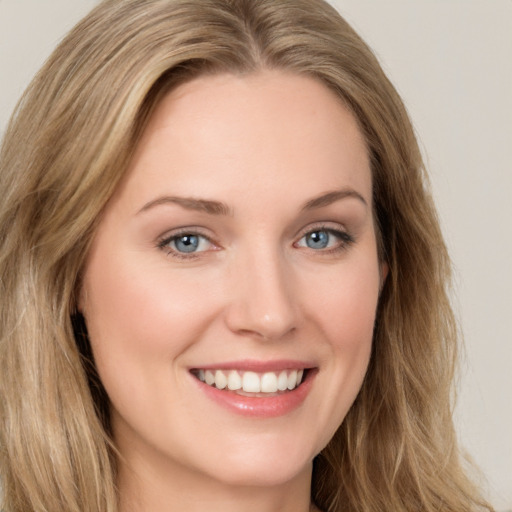 Joyful white young-adult female with long  brown hair and green eyes