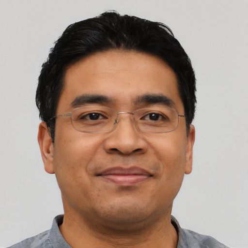 Joyful asian adult male with short  black hair and brown eyes
