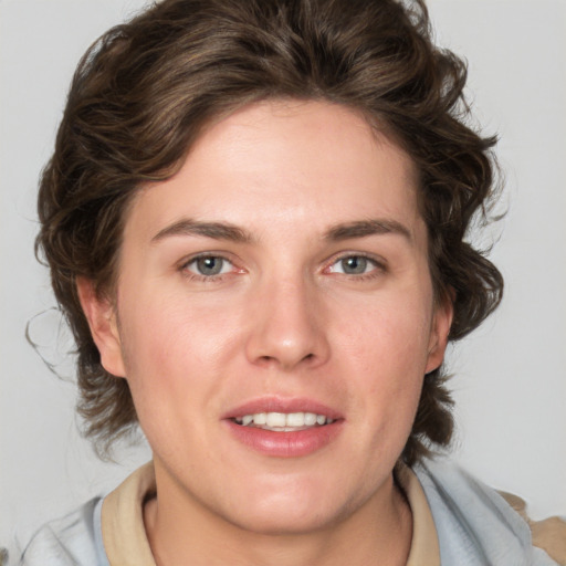 Joyful white young-adult female with medium  brown hair and blue eyes