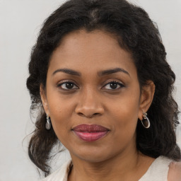 Joyful black young-adult female with medium  brown hair and brown eyes