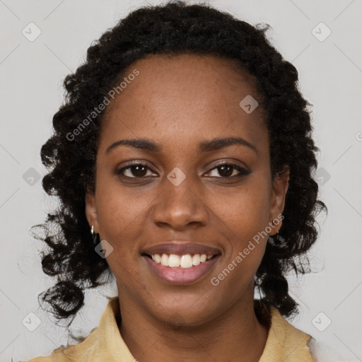 Joyful black young-adult female with long  brown hair and brown eyes