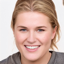 Joyful white young-adult female with medium  brown hair and blue eyes