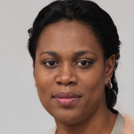 Joyful black adult female with short  black hair and brown eyes