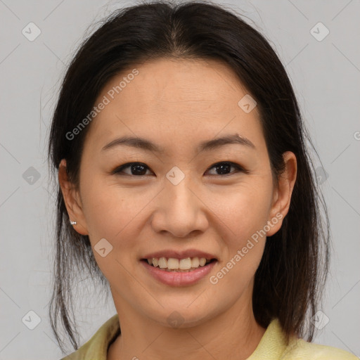 Joyful asian young-adult female with medium  brown hair and brown eyes