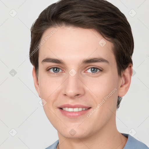 Joyful white young-adult male with short  brown hair and grey eyes