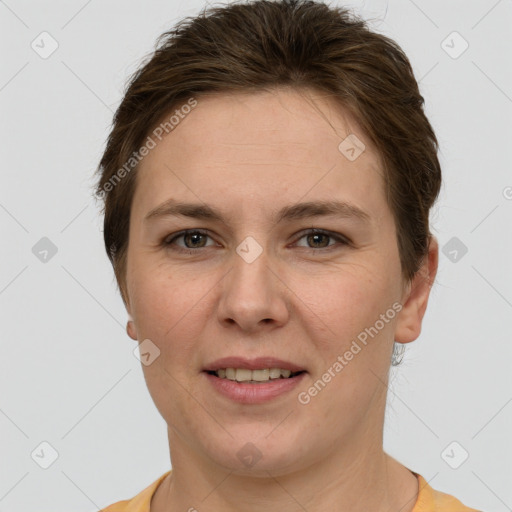 Joyful white young-adult female with short  brown hair and grey eyes