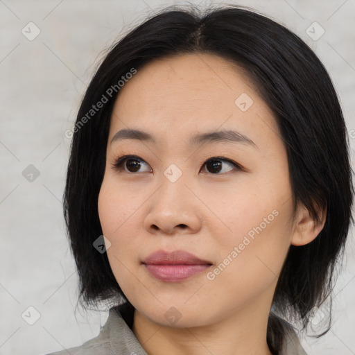 Joyful asian young-adult female with medium  black hair and brown eyes