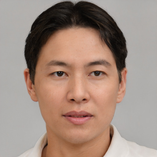 Neutral asian adult male with short  brown hair and brown eyes