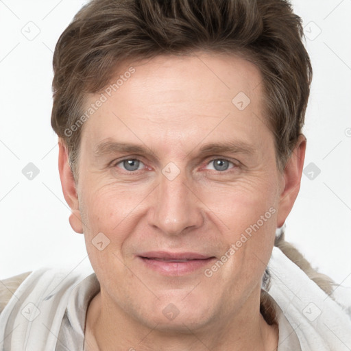 Joyful white adult male with short  brown hair and grey eyes