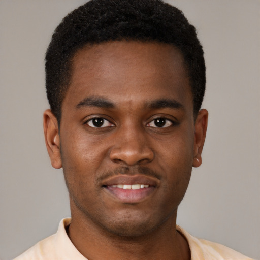 Joyful black young-adult male with short  brown hair and brown eyes