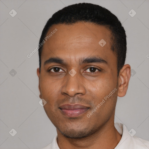 Joyful black young-adult male with short  black hair and brown eyes