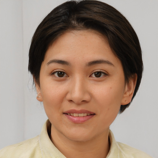Joyful white young-adult female with medium  brown hair and brown eyes