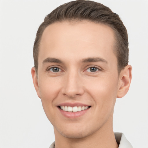 Joyful white young-adult male with short  brown hair and brown eyes