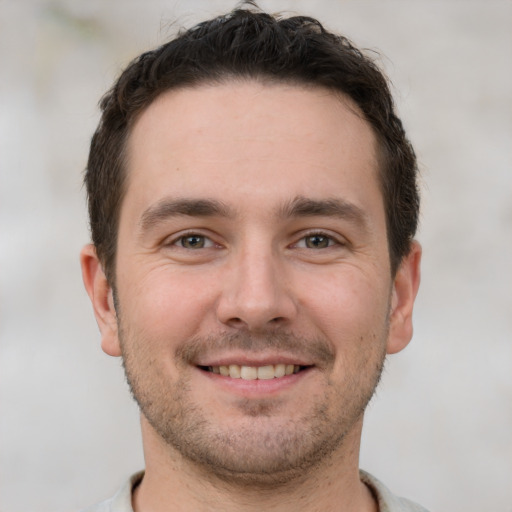 Joyful white young-adult male with short  brown hair and brown eyes