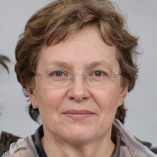 Joyful white middle-aged female with medium  brown hair and blue eyes