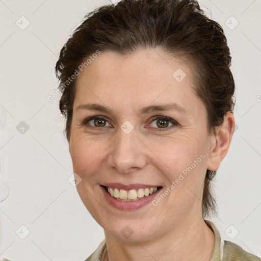 Joyful white young-adult female with medium  brown hair and green eyes