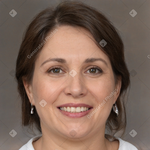 Joyful white adult female with medium  brown hair and brown eyes