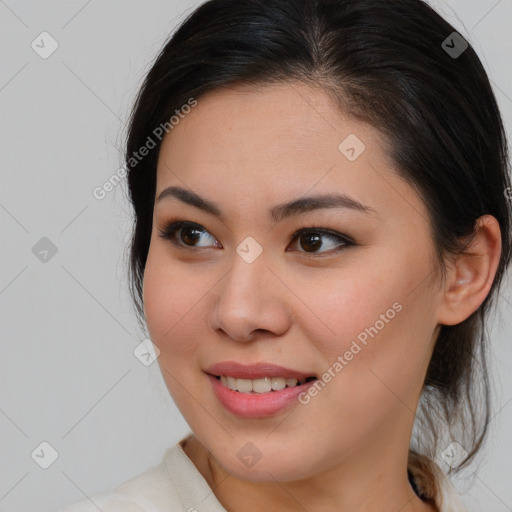 Joyful asian young-adult female with medium  brown hair and brown eyes