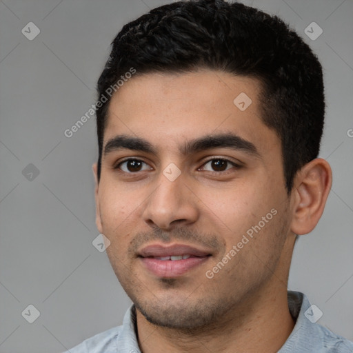 Joyful latino young-adult male with short  black hair and brown eyes