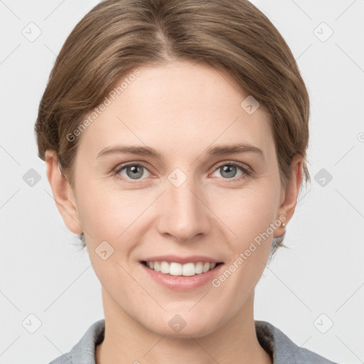 Joyful white young-adult female with short  brown hair and grey eyes