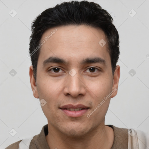 Joyful white young-adult male with short  black hair and brown eyes