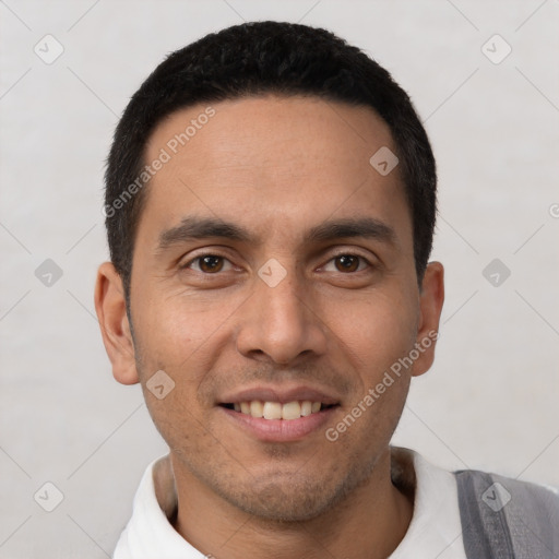 Joyful latino young-adult male with short  black hair and brown eyes