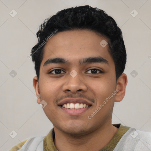 Joyful latino young-adult male with short  black hair and brown eyes