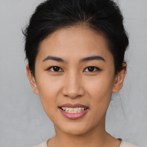 Joyful asian young-adult female with short  brown hair and brown eyes