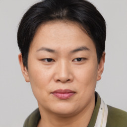 Joyful asian young-adult female with short  brown hair and brown eyes