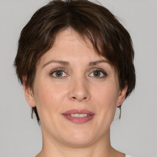 Joyful white young-adult female with medium  brown hair and green eyes