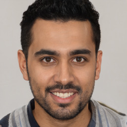 Joyful white young-adult male with short  black hair and brown eyes