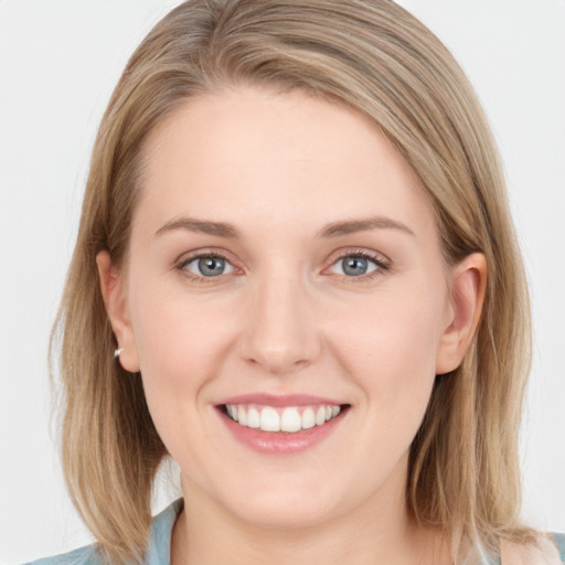 Joyful white young-adult female with long  brown hair and grey eyes