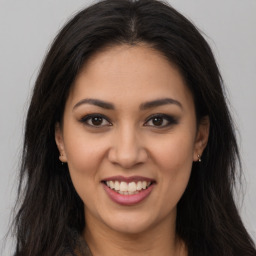 Joyful latino young-adult female with long  brown hair and brown eyes