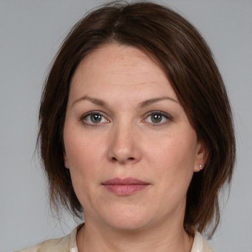 Joyful white adult female with medium  brown hair and grey eyes