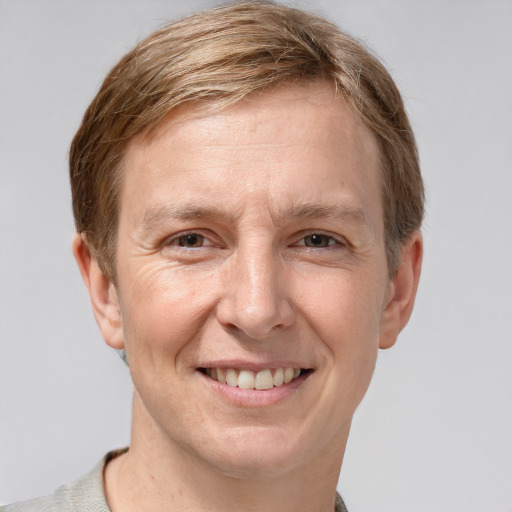 Joyful white adult male with short  brown hair and grey eyes