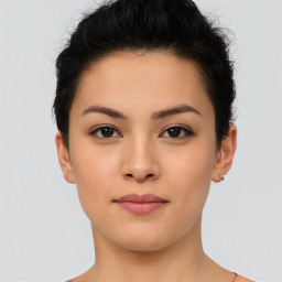 Joyful latino young-adult female with short  black hair and brown eyes