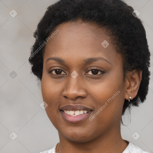 Joyful black young-adult female with short  black hair and brown eyes