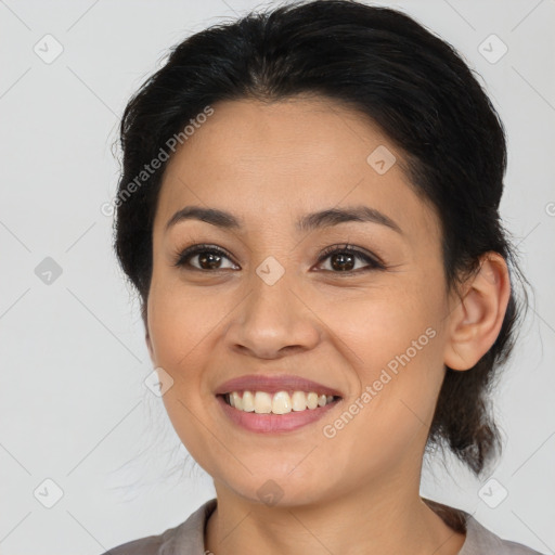 Joyful latino young-adult female with medium  brown hair and brown eyes