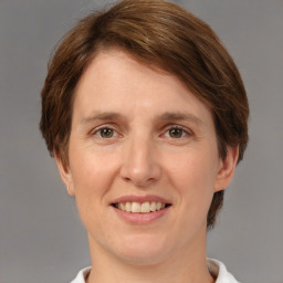 Joyful white adult female with medium  brown hair and grey eyes