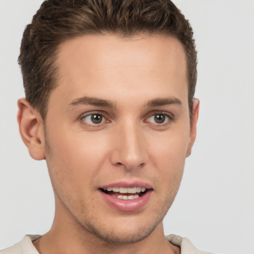 Joyful white young-adult male with short  brown hair and brown eyes