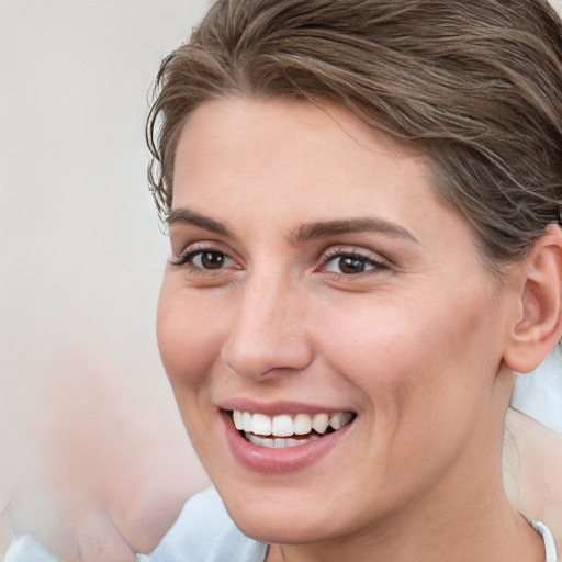 Joyful white young-adult female with medium  brown hair and blue eyes