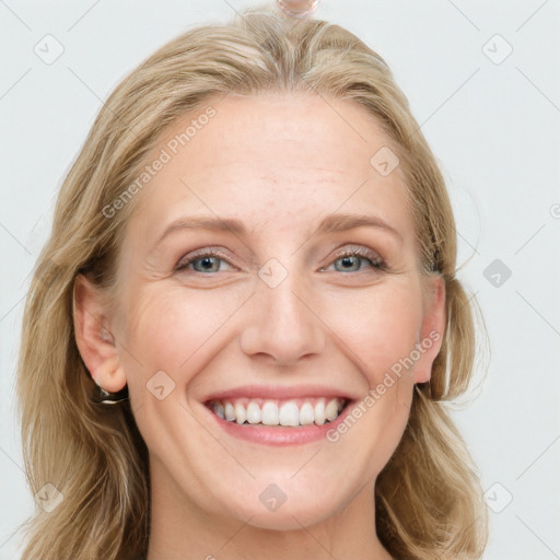 Joyful white young-adult female with long  brown hair and blue eyes