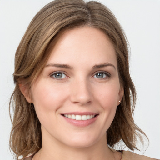 Joyful white young-adult female with medium  brown hair and blue eyes